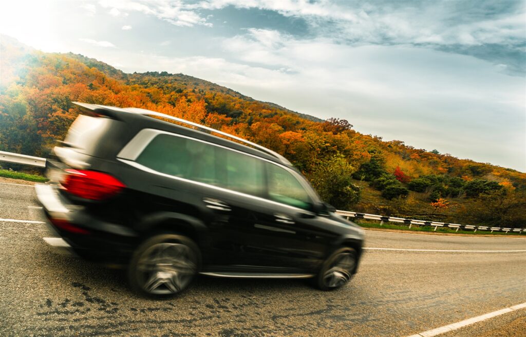 SUV Driving Down Road During Fall Season in Cherry Log, GA