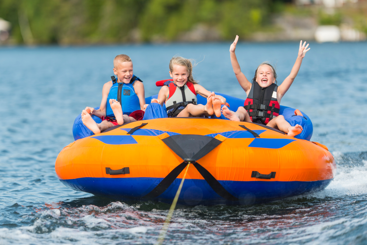 Kids Riding on Water Tub Behind Boat on Nottely Lake, Georgia