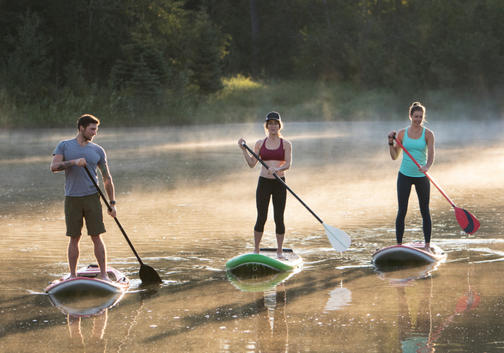 Three People Paddle Boarding On lake Blue Ridge